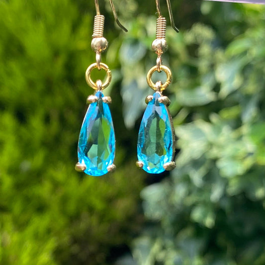 handmade clear blue  gemstone in claw setting gold birthstone earrings dangle