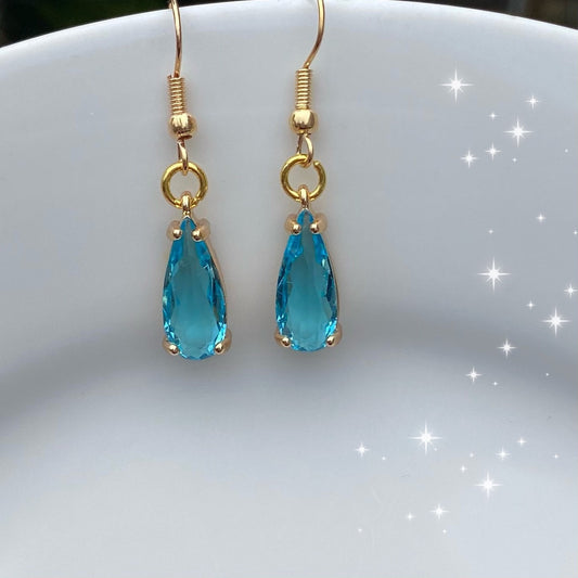 handmade clear blue  gemstone in claw setting gold birthstone earrings dangle