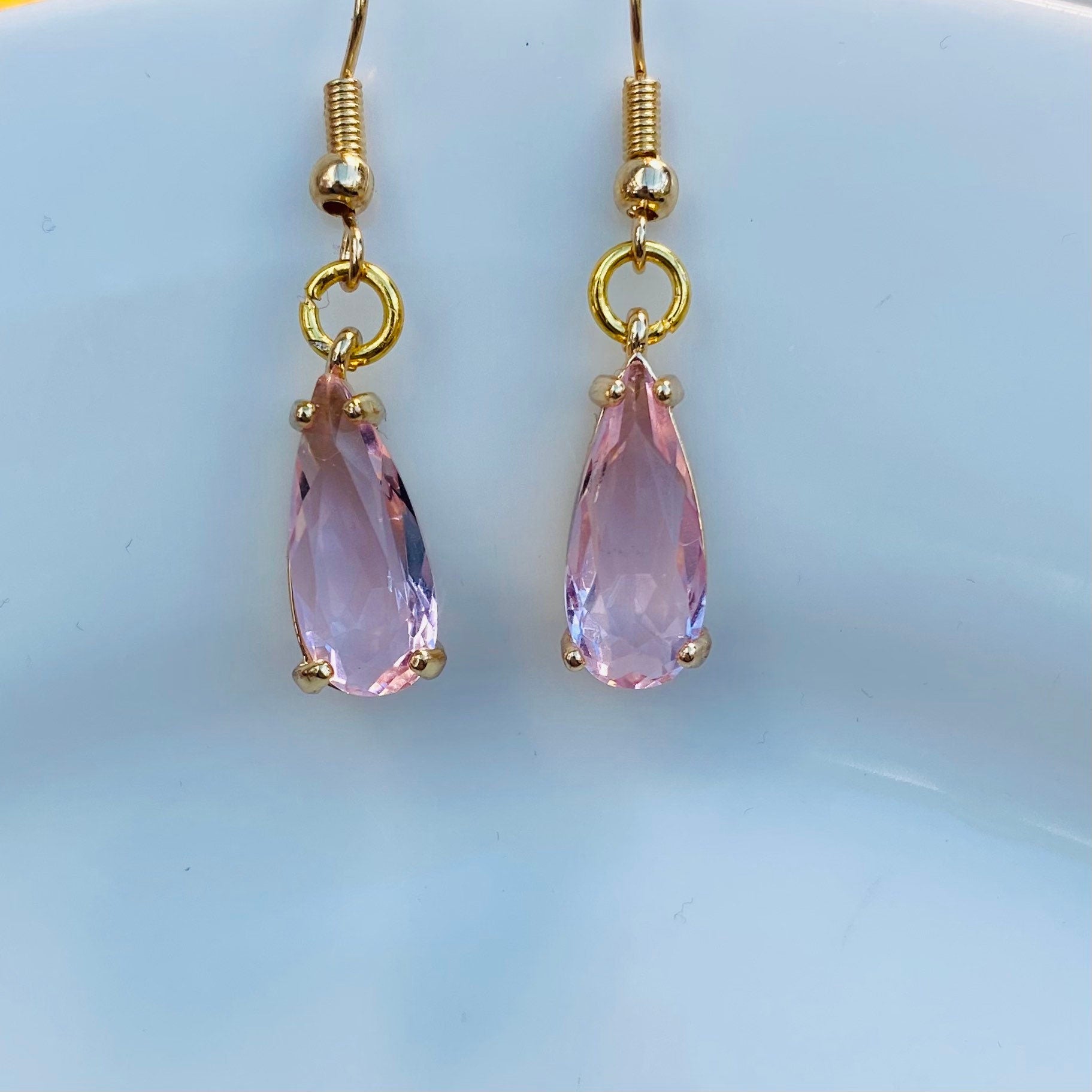 handmade clear pink gemstone in claw setting gold birthstone earrings dangle